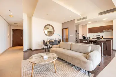 a living room with a couch and a table at Near Dubai International Cricket Stadium, Minutes drive to Mall of the Emirates, The Matrix Tower, Sports City By Deluxe Holiday Homes in Dubai