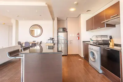 a kitchen with a washer and dryer in a room at Near Dubai International Cricket Stadium, Minutes drive to Mall of the Emirates, The Matrix Tower, Sports City By Deluxe Holiday Homes in Dubai