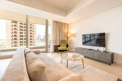 a living room with a couch and a tv at Near Dubai International Cricket Stadium, Minutes drive to Mall of the Emirates, The Matrix Tower, Sports City By Deluxe Holiday Homes in Dubai