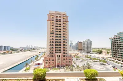 a tall building in the middle of a city at Near Dubai International Cricket Stadium, Minutes drive to Mall of the Emirates, The Matrix Tower, Sports City By Deluxe Holiday Homes in Dubai