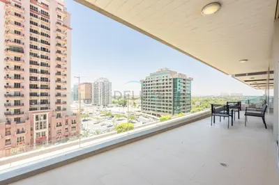 a balcony with chairs and a view of a city at Near Dubai International Cricket Stadium, Minutes drive to Mall of the Emirates, The Matrix Tower, Sports City By Deluxe Holiday Homes in Dubai