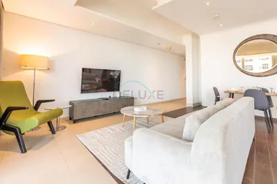 a living room with a couch and a tv at Near Dubai International Cricket Stadium, Minutes drive to Mall of the Emirates, The Matrix Tower, Sports City By Deluxe Holiday Homes in Dubai