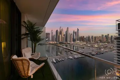 a balcony with chairs and a view of a harbor at Luxury High floor apartment Atlantis & palm view in Dubai