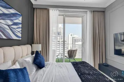 a bedroom with a bed and a large window at Luxury High floor apartment Atlantis & palm view in Dubai