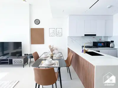 a kitchen and dining room with a table and chairs at Bright and Modern 1BR Binghatti Amber with City View in Dubai