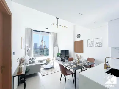 a kitchen and living room with a table and chairs at Bright and Modern 1BR Binghatti Amber with City View in Dubai
