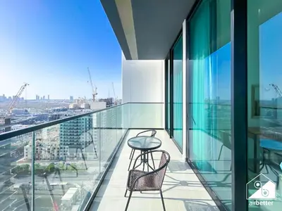 a balcony with a table and chairs on a building at Bright and Modern 1BR Binghatti Amber with City View in Dubai