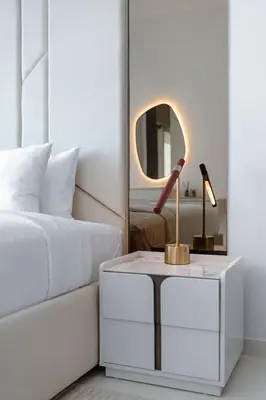 a bedroom with a bed and a table with a mirror at Seafront 3BR with maid's - Grand Bleu by Elie Saab in Dubai