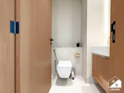 a bathroom with a white toilet and a sink at Cozy Luxury l1BR Apartment in Binghatti Amber in Dubai