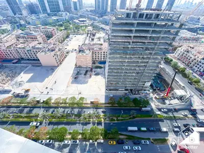 an aerial view of a tall building in a city at Cozy Luxury l1BR Apartment in Binghatti Amber in Dubai