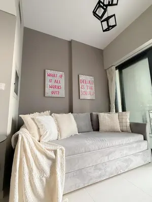 a living room with a couch in a room at Sunset Balcony - Sleeps 4 - Water View - Pool n Gym - 1BR in Dubai