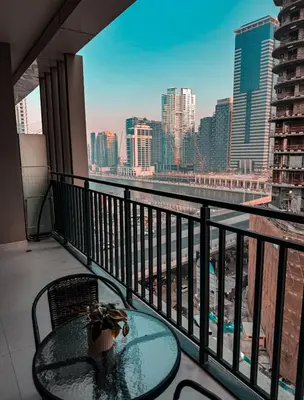 a balcony with a table and a view of the city at Sunset Balcony - Sleeps 4 - Water View - Pool n Gym - 1BR in Dubai