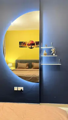 a room with a bed with a round mirror at Livincci - Luxury 1 Bed Apartment in JLT-10 in Dubai