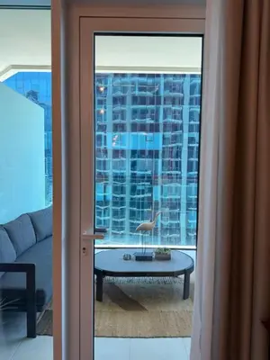 a view of a living room with a large window at Canal View 1BR - Business Bay - Fully Furnished in Dubai