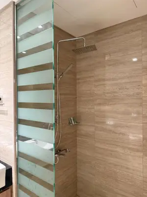 a shower with a glass door in a bathroom at Canal View 1BR - Business Bay - Fully Furnished in Dubai