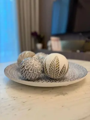 four easter eggs on a plate on a table at Canal View 1BR - Business Bay - Fully Furnished in Dubai