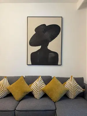 a picture of a woman wearing a hat on a couch at Canal View 1BR - Business Bay - Fully Furnished in Dubai