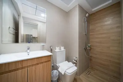 a bathroom with a toilet and a sink and a shower at Contemporary Studio Getaway in Jebel Ali in Dubai