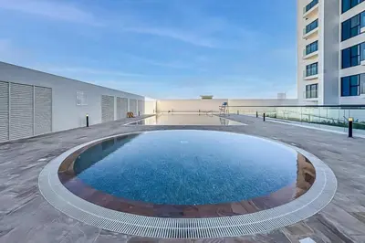 a large swimming pool on top of a building at Contemporary Studio Getaway in Jebel Ali in Dubai