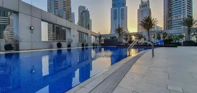 a large swimming pool in a city with tall buildings at Best Marina & Ain Dubai View | Steps to JBR beach in Dubai