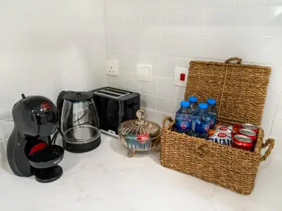 a kitchen counter with bottles of water and a coffee maker at Best Marina & Ain Dubai View | Steps to JBR beach in Dubai