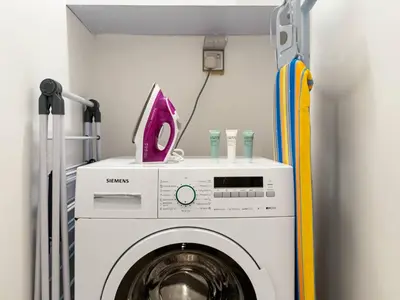 a washing machine with a pink item on top of it at Best Marina & Ain Dubai View | Steps to JBR beach in Dubai