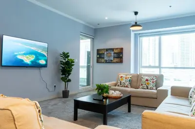 a living room with a couch and a table at Peace Of The Soul By Lagom Jumeirah Lake Towers in Dubai
