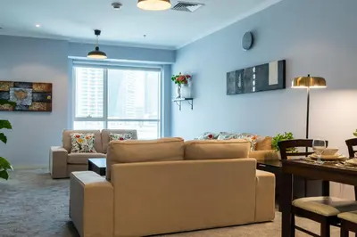 a living room with a couch and a table at Peace Of The Soul By Lagom Jumeirah Lake Towers in Dubai