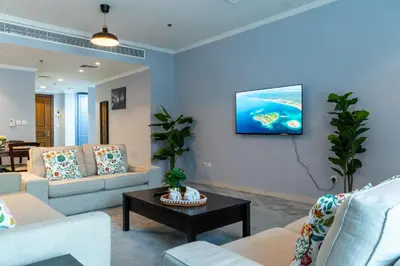 a living room with couches and a tv on a wall at Peace Of The Soul By Lagom Jumeirah Lake Towers in Dubai