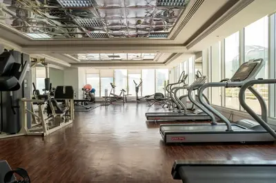 a gym with treadmills and elliptical machines at Peace Of The Soul By Lagom Jumeirah Lake Towers in Dubai