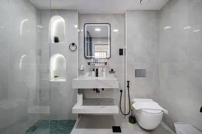 a white bathroom with a sink and a toilet at Chic 2BR Steps to JBR Beach in Dubai