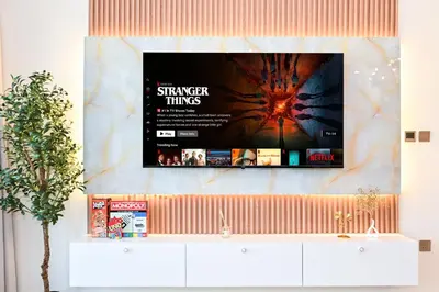 a flat screen tv hanging on a wall at New Luxe 2BR in Burj Royale, 1 Min Walk to Dubai Mall,40th Floor, Burj Khalifa View Pool, Wifi, Gym in Dubai