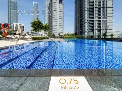 a swimming pool in a city with tall buildings at Creek Crescent by Emaar, Dubai Creek Harbour in Dubai