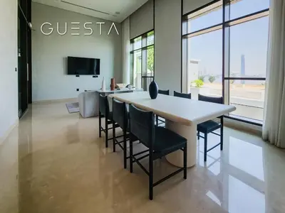 a dining room with a table and chairs at Creek Crescent by Emaar, Dubai Creek Harbour in Dubai
