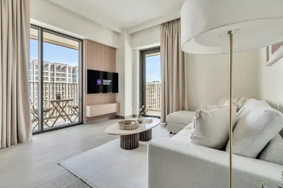 a living room with a couch and a tv at 1-Bed at Creek Beach with Pool, Gym and Balcony in Dubai