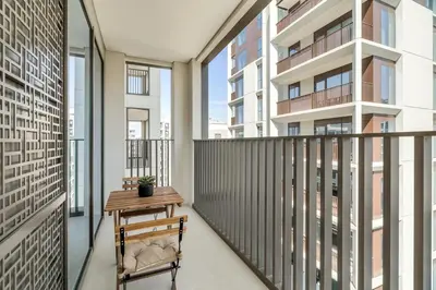 a balcony with a table and a chair at 1-Bed at Creek Beach with Pool, Gym and Balcony in Dubai