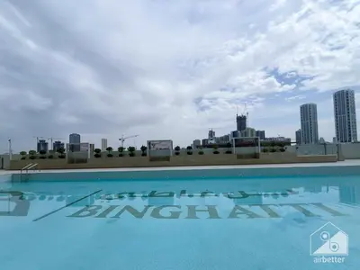 a swimming pool on the roof of a building at Stylish 1 Bedroom with Pool Access in JVC in Dubai