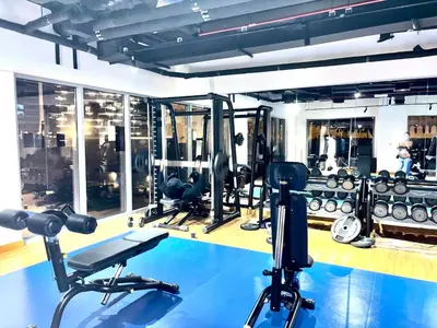 a gym with several treadmills and weights at The Greendoor Downtown - Burj view in Dubai