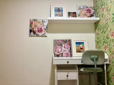 a desk with pictures on a wall with a chair at The Greendoor Downtown - Burj view in Dubai