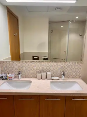a bathroom with two sinks and a large mirror at The Greendoor Downtown - Burj view in Dubai