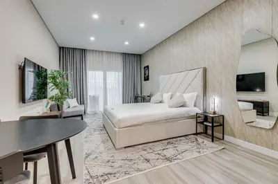 a bedroom with a bed and a living room at Knokey Cozy Studio Apartments in Business Bay in Dubai