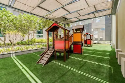 a playground with a train on the grass at Knokey Cozy Studio Apartments in Business Bay in Dubai