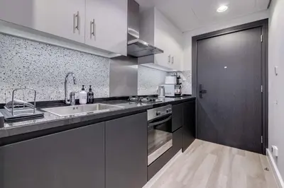 a kitchen with a sink and a counter top at Knokey Cozy Studio Apartments in Business Bay in Dubai