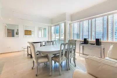 a dining room with a table and chairs at Modern 1BR with Balcony and Marina Views in Al Majara 2 in Dubai