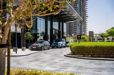 a group of cars parked in front of a building at Creek Harbour Skyline Burj Khalifa & Sea View in Dubai