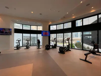 a gym with treadmills and ellipticals in a building at Address Beach Resort - 1BDR With Private Beach in Dubai