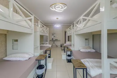 a dorm room with two beds and desks at Apartment in Downtown As Dormitory Room for male in Dubai