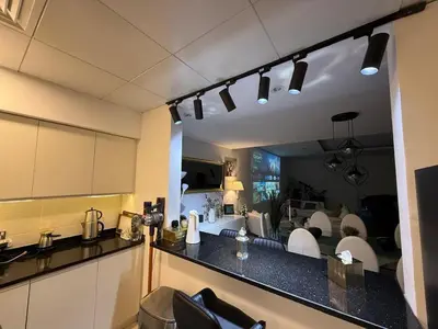 a kitchen with a view of a living room at Oceana Residences Holiday Beach Home in Dubai