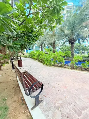 a park bench in a park with palm trees at Oceana Residences Holiday Beach Home in Dubai