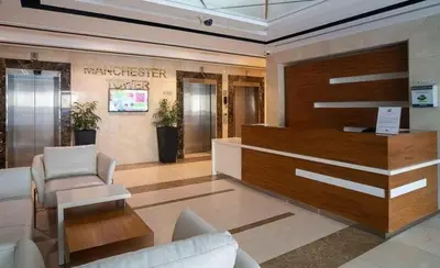 a lobby of a building with a reception desk at Manchester Tower Dubai Marina in Dubai
